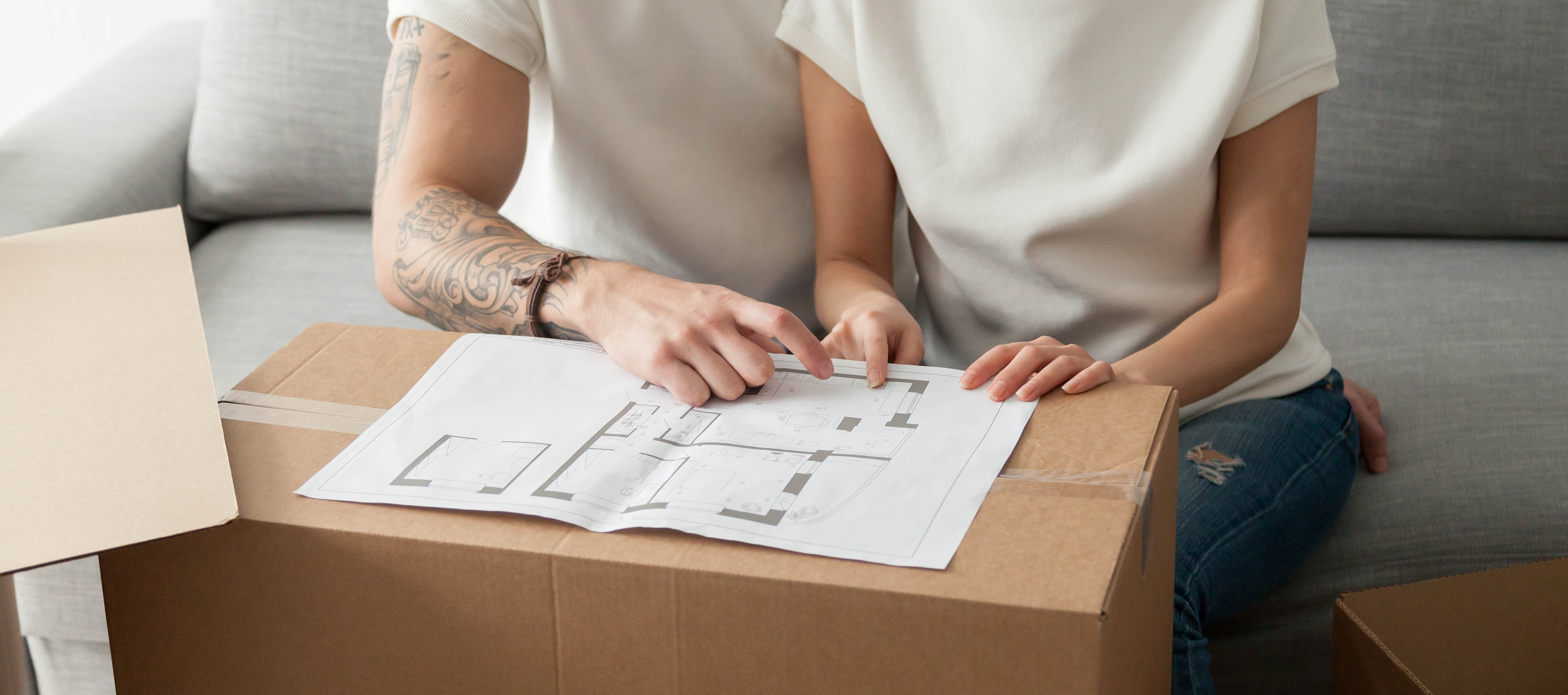 Couple discussing house plan, moving in new home, planning renov