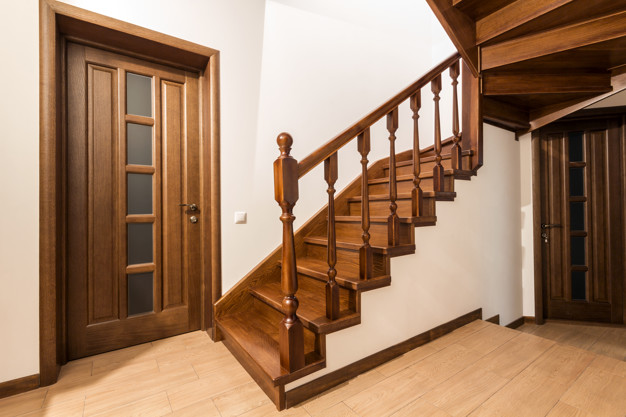 Modern brown oak wooden stairs and doors in new renovated house